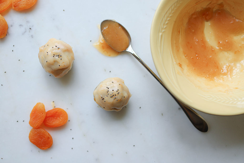 Raw apricot donut holes are pictured with dry apricots and apricot jam.