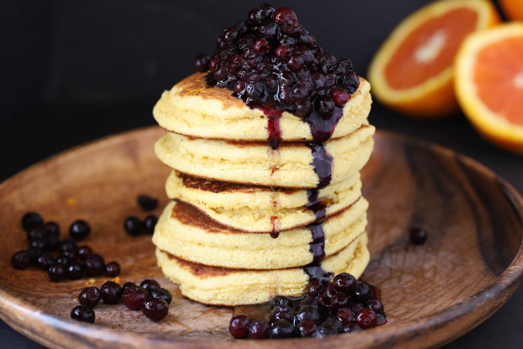 a stack of pancakes with blueberry compote
