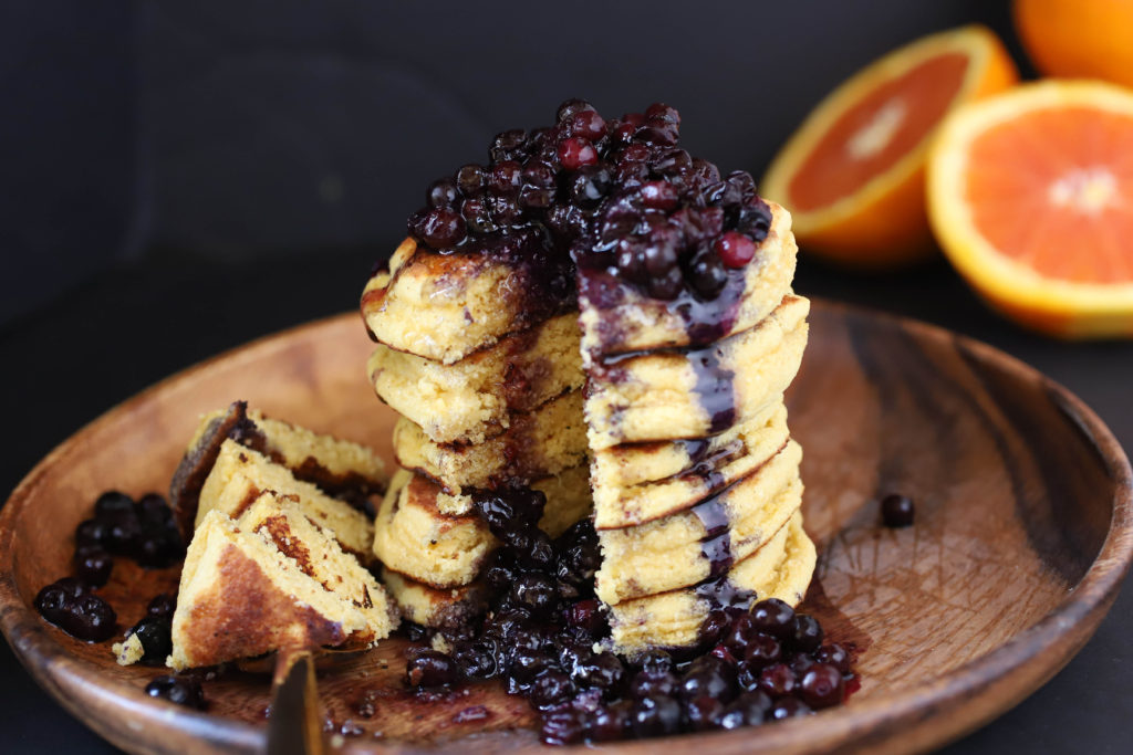 a stack of chickpea pancakes with blueberry compote