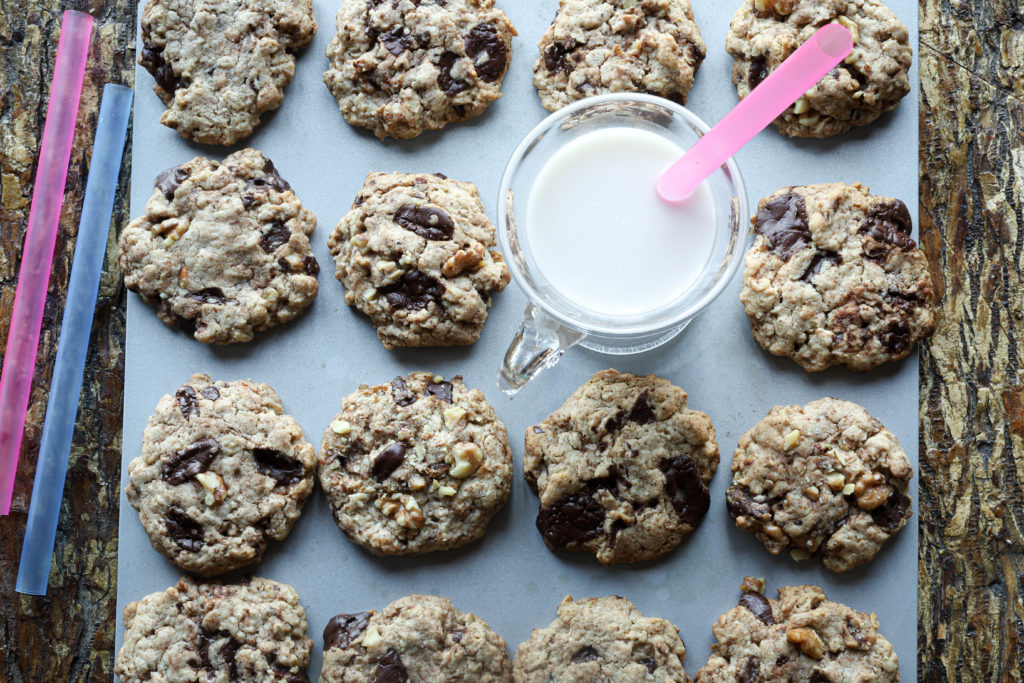 Vegan chocolate chunk cookies with almond butter and walnuts and a glass of almond milk