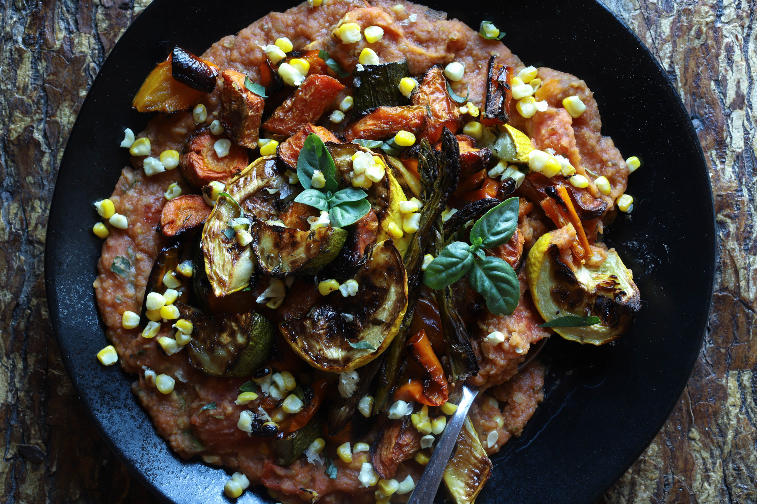 Summery red lentils with tomatoes, basil, corn, and roasted Mediterranean vegetables