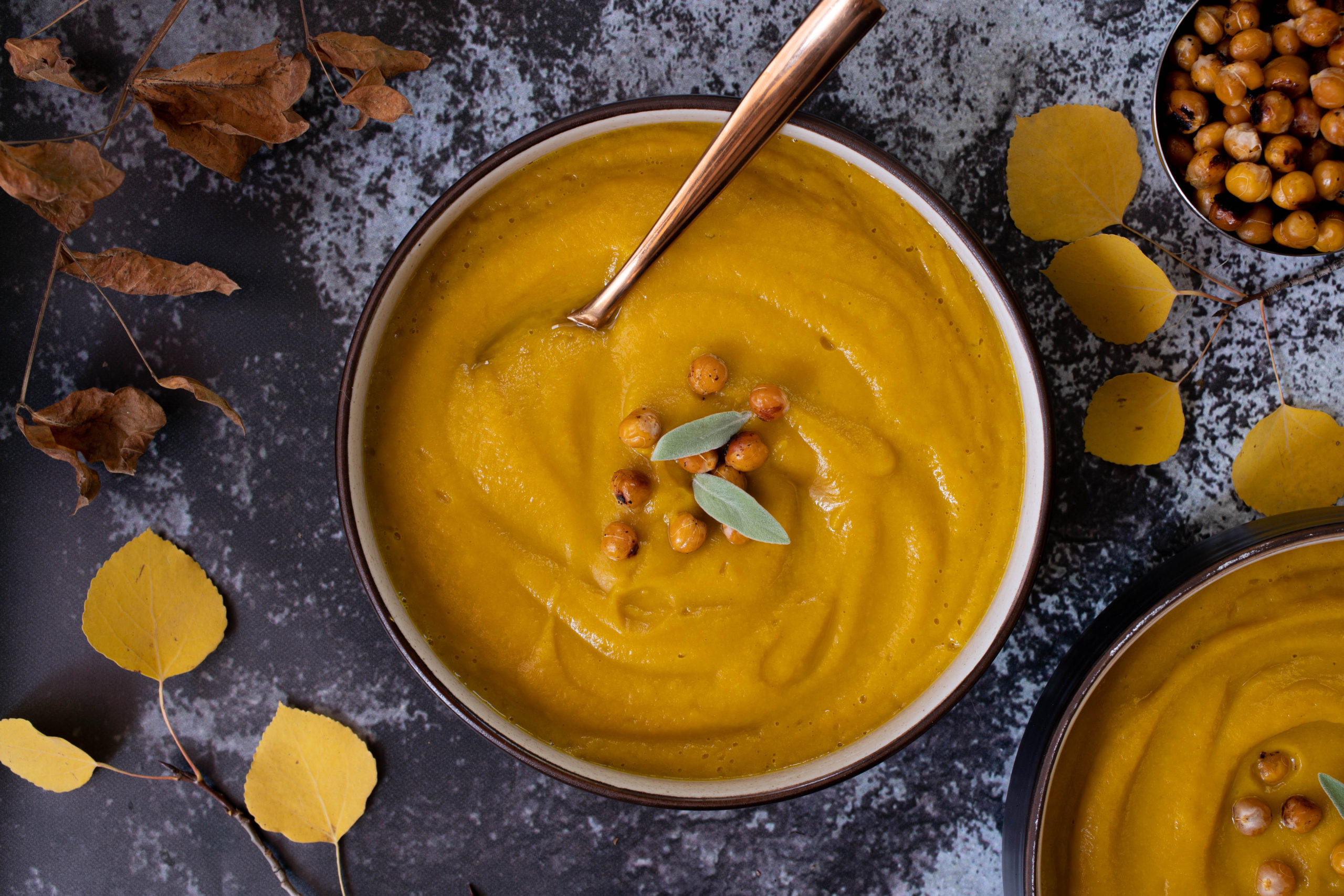 Orange butternut squash soup with crispy chickpeas and sage