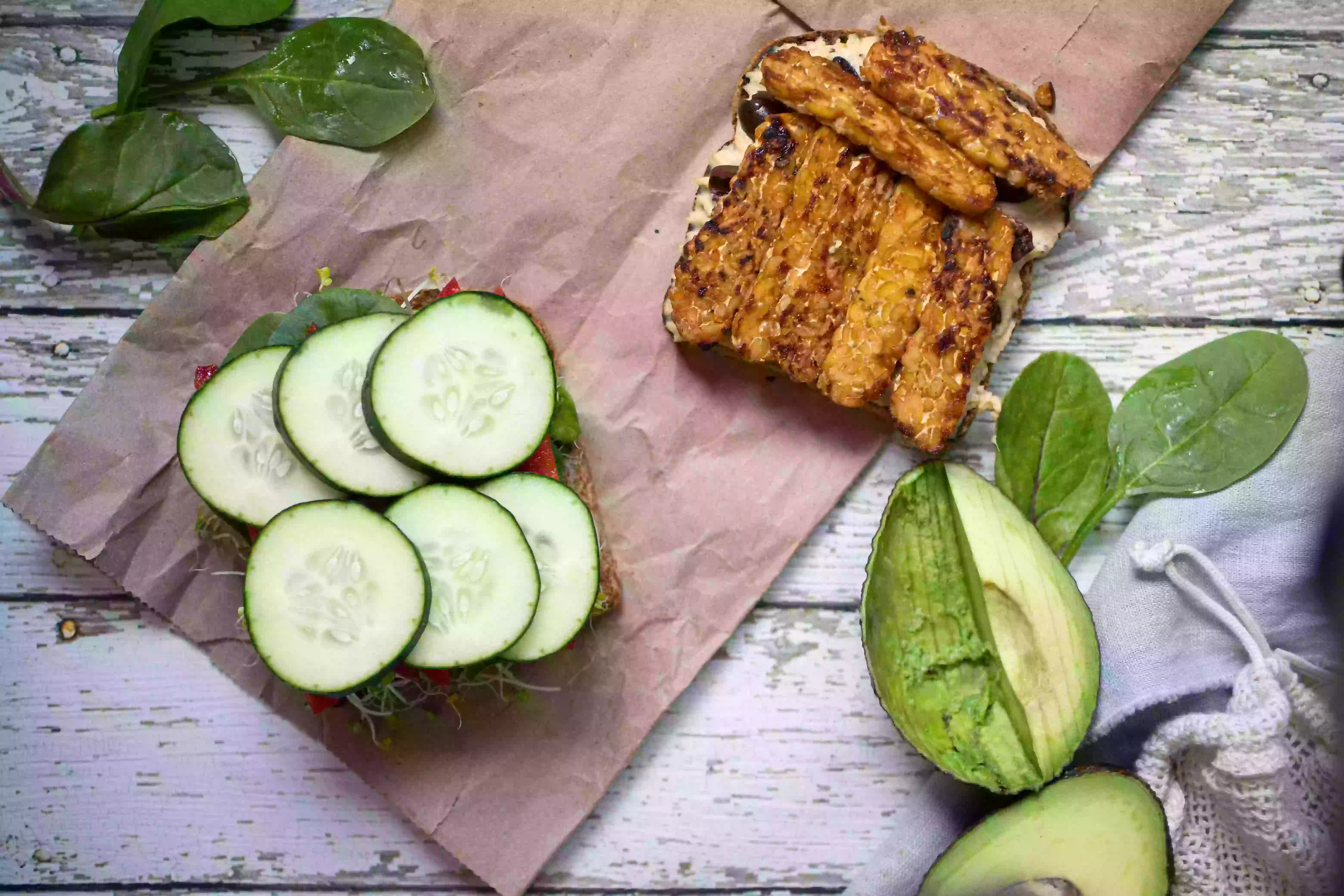 open-faced tempeh bacon sandwich with cucumbers and greens