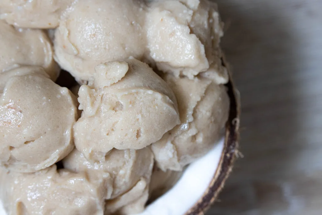 Close up of the texture of the dessert smoothie served in half a coconut