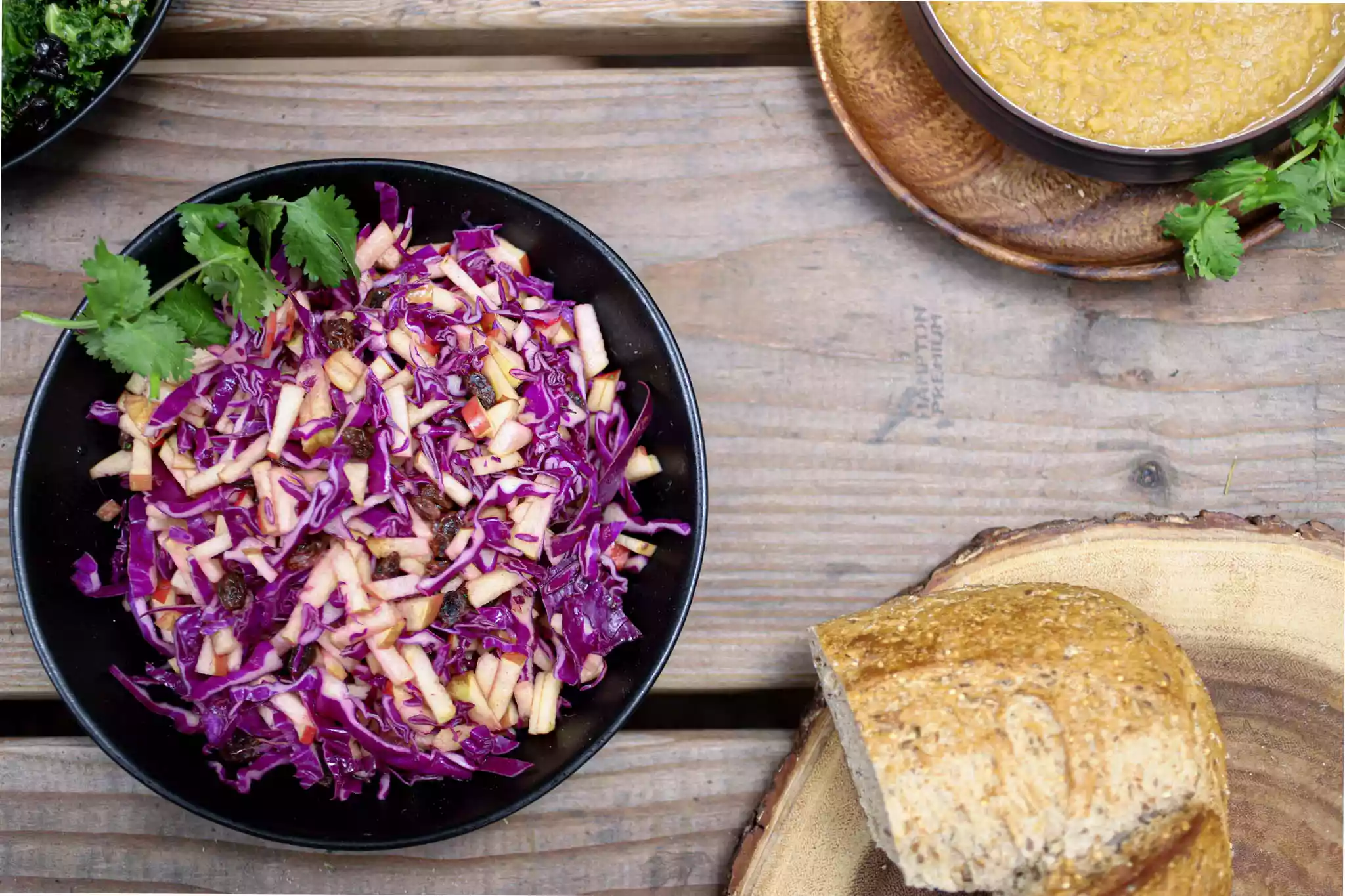 cabbage slaw on a picnic table with assorted other food
